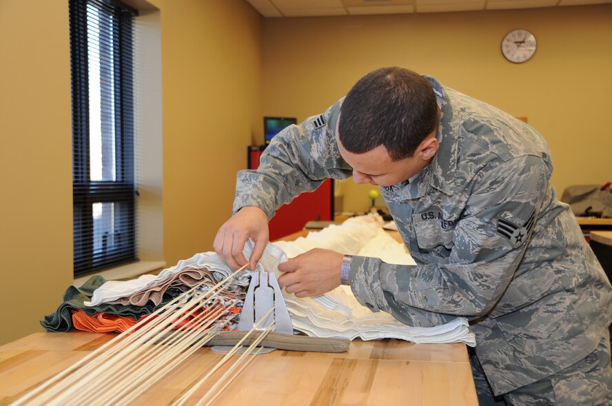 Senior Airman Ryan Stark, 442nd Operations Support Flight aircrew flight equipment technician, aligns and inspects the rigging of the main canopy prior to packing the parachute, Feb. 11, 2012. The 442nd OSF is part of the 442nd Fighter Wing, an A-10 Thunderbolt II Air Force Reserve unit at Whiteman. (U.S. Air Force photo/Staff Sgt. Lauren Padden) 