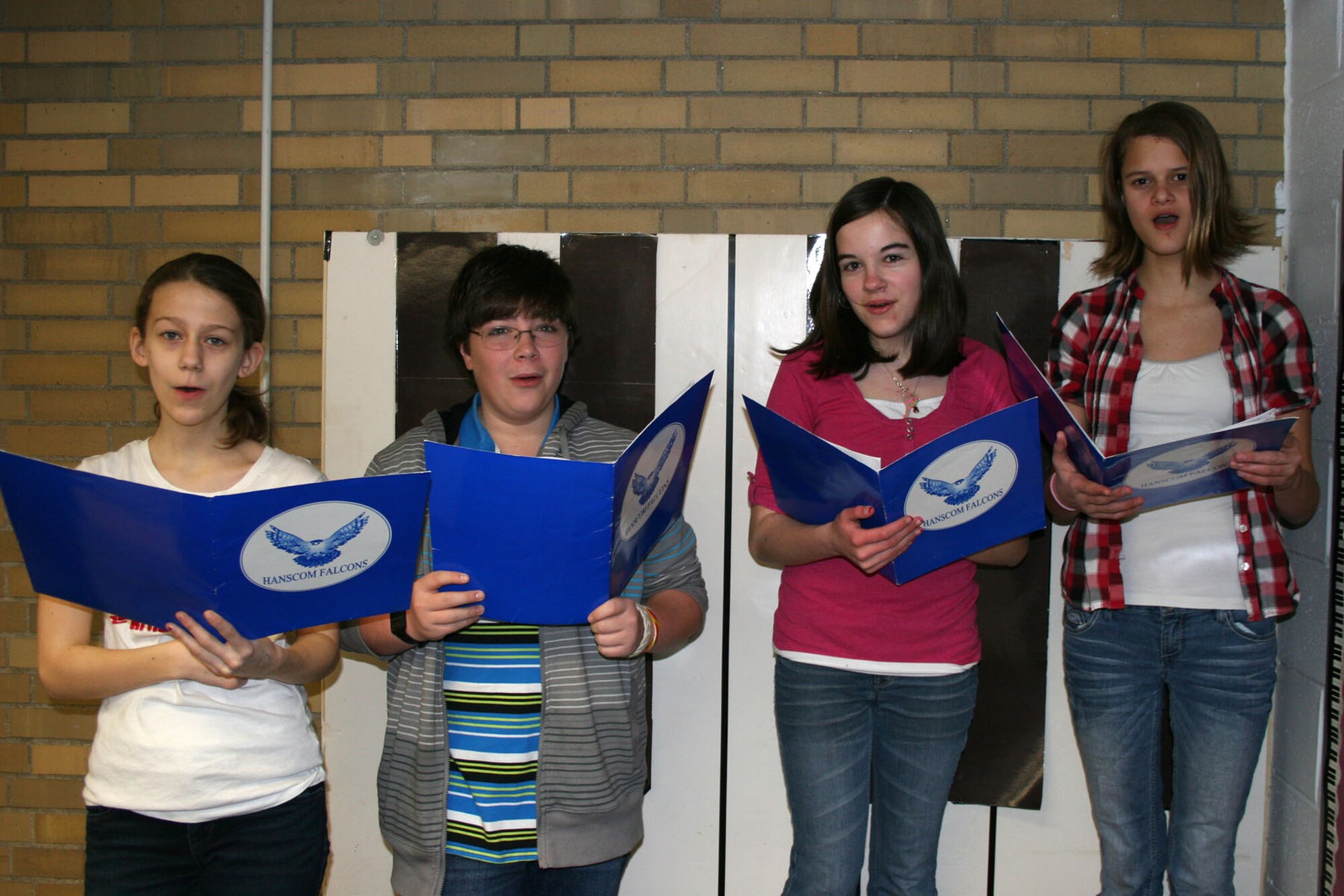 HANSCOM AIR FORC E BASE, Mass. – Eva Alpar, Rett Genatempo, Katelyn Miller and Rebecca McIllece practice singing recently at Hanscom Middle School. These four students were selected to participate in the MMEA Eastern Massachusetts District Junior Music Festival. After auditions of 1,040 students from 135 public and private schools, 480 students from grades seven through nine were selected to participate in this event. They will rehearse with guest conductors and then perform in a concert at Lincoln Sudbury Regional High School on March 17. Eva Alpar and Rett Genatempo will sing with the mixed choir and Katelyn Miller and Rebecca McIllece will sing with the treble choir. (Courtesy photo)