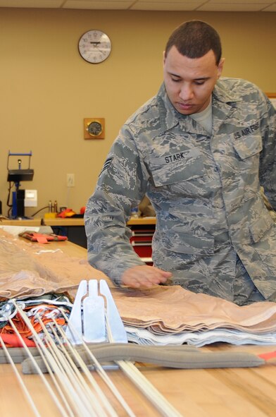 Senior Airman Ryan Stark, 442nd Operations Support Flight aircrew flight equipment technician, inspects the fabric of the main canopy for any abnormalities prior to packing the parachute, Feb. 11, 2012. The 442nd OSF is part of the 442nd Fighter Wing, an A-10 Thunderbolt II Air Force Reserve unit at Whiteman. (U.S. Air Force photo/Staff Sgt. Lauren Padden) 