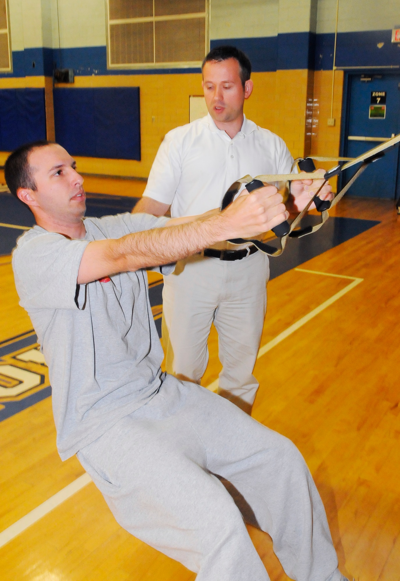Greg Reynolds, at right,  HAWC exercise physiologist, assists Staff Sgt. Trent Schultz during Total Force Fitness Program corrective exercise time. (U. S. Air Force photo by Sue Sapp)