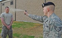 U.S. Air Force Staff Sgt. Daniel Sholar sprays Airman 1st Class Phillip Passmore with pepper spray at Seymour Johnson Air Force Base, N.C., Feb. 17, 2012. According to Air Force Manual 31-222, security forces personnel and augmentees must experience the effect of pepper spray before they can carry it. Sholar, 4th Security Forces Squadron trainer, hails from Wallace, N.C.  Passmore, 4th Security Forces Squadron augmentee and 4th Aircraft Maintenance Squadron crew chief, hails from Nantahala, N.C. (U.S. Air Force photo/Senior Airman Gino Reyes/Released)
