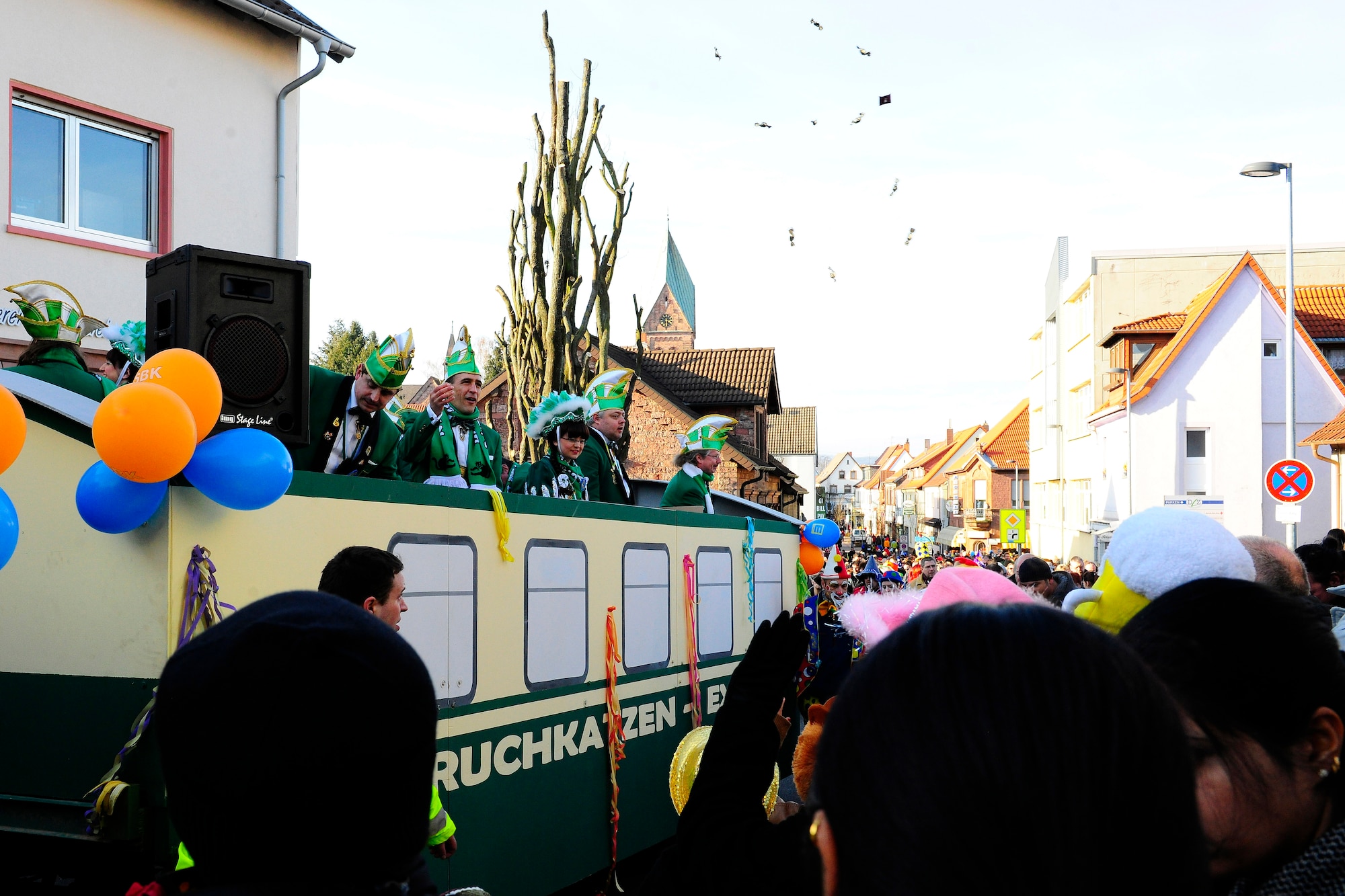 Parade participates throw candy into the crowd during the annual celebration of Fasching parade, Ramstein Village, Germany, Feb. 21, 2011. This annual event is a pre-Lenten carnival which is celebrated with the donning of wild and fancy costumes to chase away the evil spirits of winter in preparation for spring. (U.S. Air Force photo by Staff Sgt. Chris Willis) 