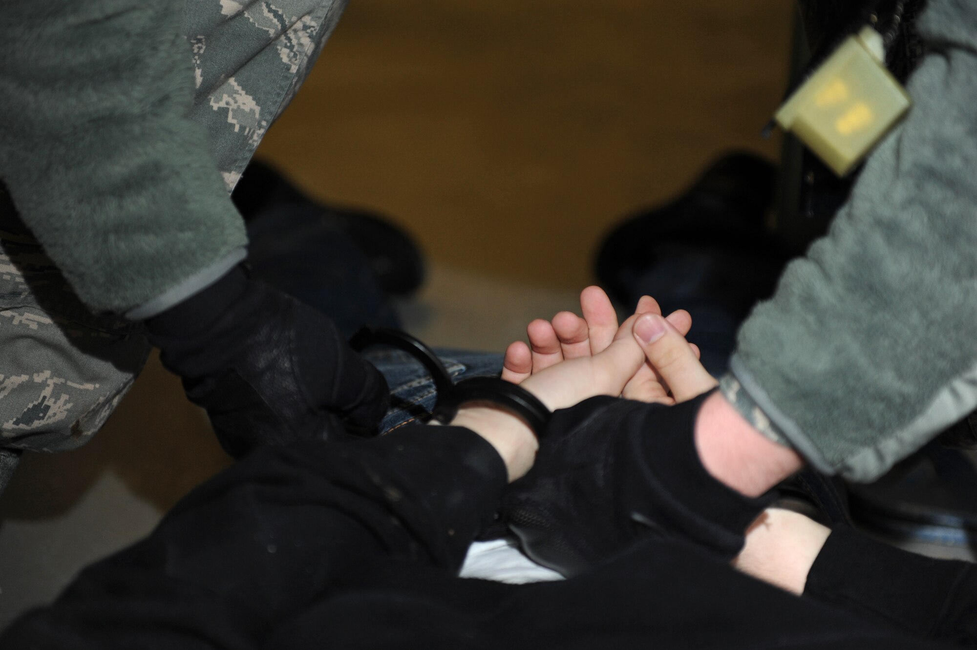 SPANGDAHLEM AIR BASE, Germany – A suspect is handcuffed during an active-shooter training exercise at Bldg. 103 here Feb. 17. The 52nd Fighter Wing conducted the exercise to test the wing’s response to an active-shooter situation. Training like this readies the base to respond to real emergency events protecting base members and U.S. government assets. (U.S. Air Force photo by Airman 1st Class Matthew B. Fredericks/Released)