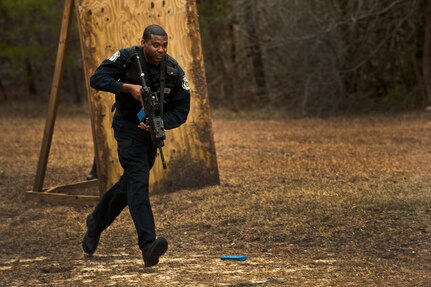 Courtney Towns moves for cover during a “Shoot, Move, Communicate” training course at the Combat Arms Training and Maintenance range at Joint Base Charleston - Air Base Feb. 16. The training teaches Airmen to react to a hostile shooter by using cover and effective communication to maneuver and engage the target. Towns is a 628th Security Forces Squadron police officer at JB Charleston - Air Base. (U.S. Air Force photo by Airman 1st Class George Goslin)