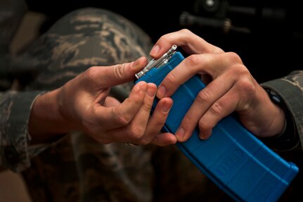 Staff Sgt. Christina Andros reloads a magazine during a “Shoot, Move, Communicate” training course at the Combat Arms Training and Maintenance range at Joint Base Charleston - Air Base  Feb. 16. The training teaches Airmen to react to a hostile shooter by using cover and effective communication to maneuver and engage the target. Andros is e 628th Security Forces Squadron patrolman at JB Charleston - Air Base. (U.S. Air Force photo by Airman 1st Class George Goslin)