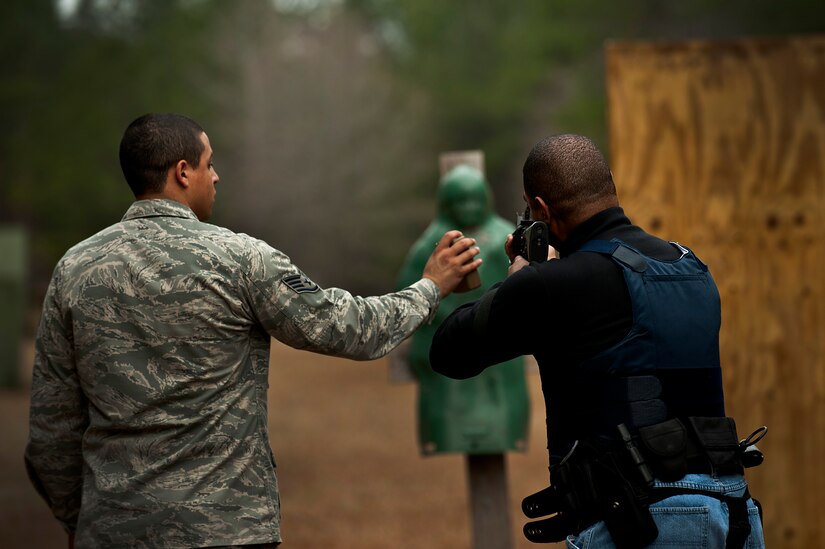 Staff Sgt. David Perez times the firing and reload speed of Guy Jones during a “Shoot, Move, Communicate” training course at the Combat Arms Training and Maintenance range at Joint Base Charleston - Air Base Feb. 16. The training teaches Airmen to react to a hostile shooter by using cover and effective communication to maneuver and engage the target. Perez is a 628th Security Forces Squadron security forces trainer and Jones is a 628th SFS flight chief at JB Charleston - Weapons Station. (U.S. Air Force photo by Airman 1st Class George Goslin/Released)