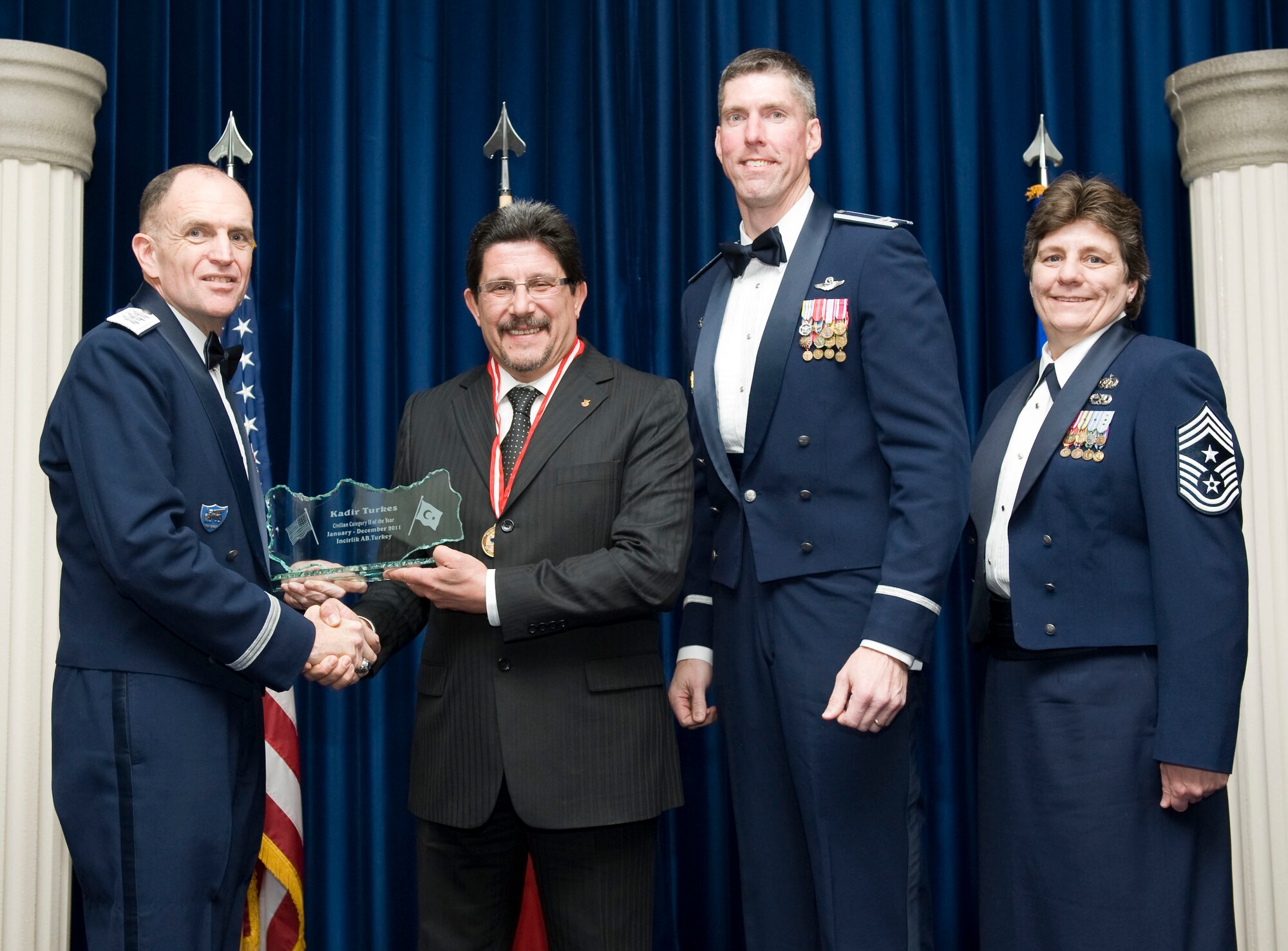 Kadir Turkes, 39th Contracting Squadron, receives the 2011 39th Air Base Wing Civilian Category II of the Year award from Lt. Gen. Ralph J. Jodice II, commander of Allied Air Component Command Headquarters in Izmir, Turkey, Feb. 21, 2012, at Incirlik Air Base, Turkey. The annual awards banquet is held to recognize members of the 39th ABW who excelled in the 2011 calendar year. (U.S. Air Force photo by Senior Airman Clayton Lenhardt/Released)