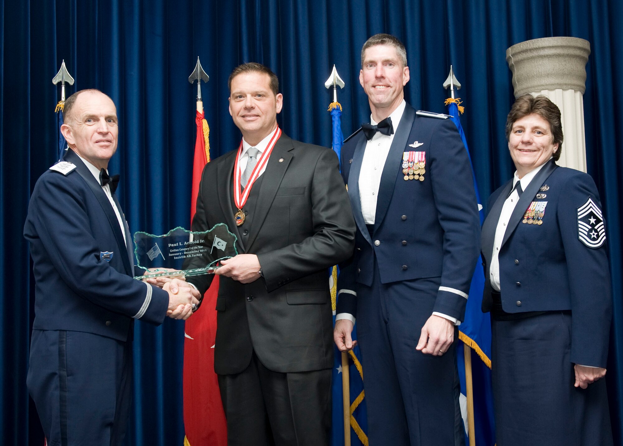 Paul Arnold Jr., 39th Civil Engineer Squadron, receives the 2011 39th Air Base Wing Civilian Category I of the Year award from Lt. Gen. Ralph J. Jodice II, commander of Allied Air Component Command Headquarters in Izmir, Turkey, Feb. 21, 2012, at Incirlik Air Base, Turkey. The annual awards banquet is held to recognize members of the 39th ABW who excelled in the 2011 calendar year. (U.S. Air Force photo by Senior Airman Clayton Lenhardt/Released)