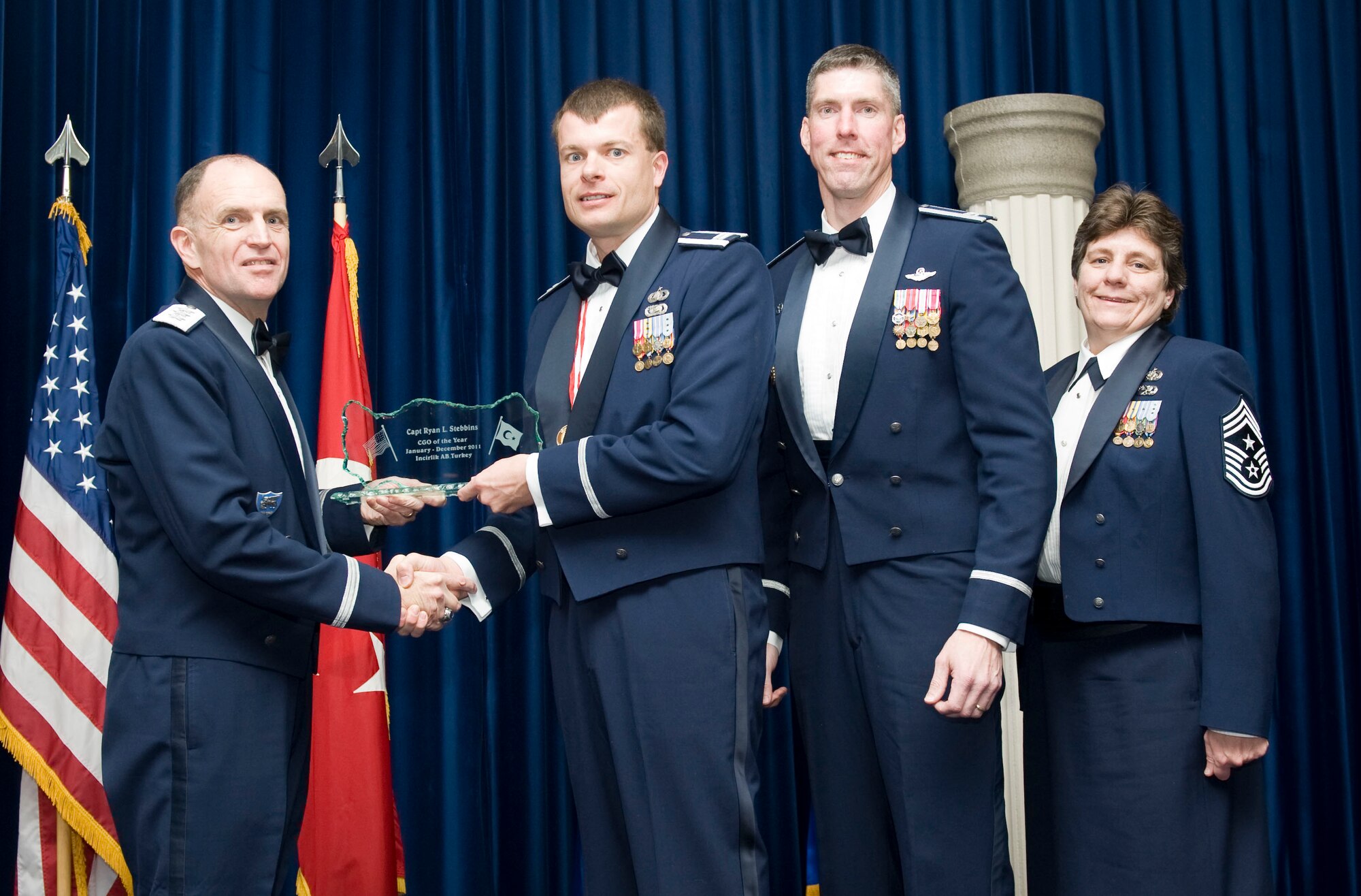Capt. Ryan Stebbins, 39th Force Support Squadron, receives the 2011 39th Air Base Wing Company Grade Officer of the Year award from Lt. Gen. Ralph J. Jodice II, commander of Allied Air Component Command Headquarters in Izmir, Turkey, Feb. 21, 2012, at Incirlik Air Base, Turkey. The annual awards banquet is held to recognize members of the 39th ABW who excelled in the 2011 calendar year. (U.S. Air Force photo by Senior Airman Clayton Lenhardt/Released)