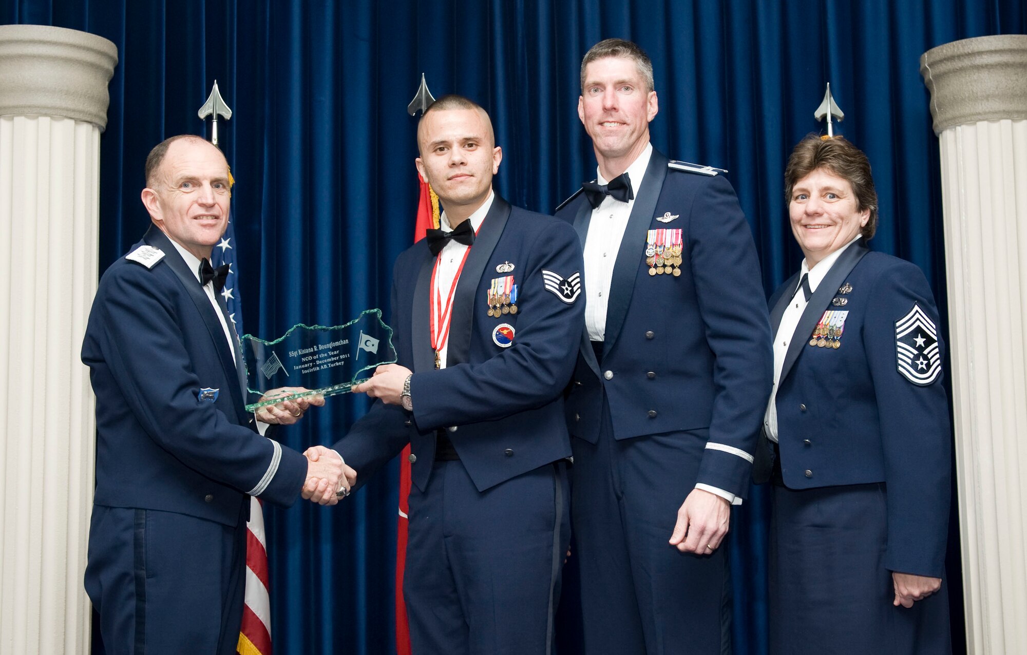 Staff Sgt. Kitsana Dounglomchan, 39th Force Support Squadron, receives the 2011 39th Air Base Wing Noncommissioned Officer of the Year award from Lt. Gen. Ralph J. Jodice II, commander of Allied Air Component Command Headquarters in Izmir, Turkey, Feb. 21, 2012, at Incirlik Air Base, Turkey. The annual awards banquet is held to recognize members of the 39th ABW who excelled in the 2011 calendar year. (U.S. Air Force photo by Senior Airman Clayton Lenhardt/Released)