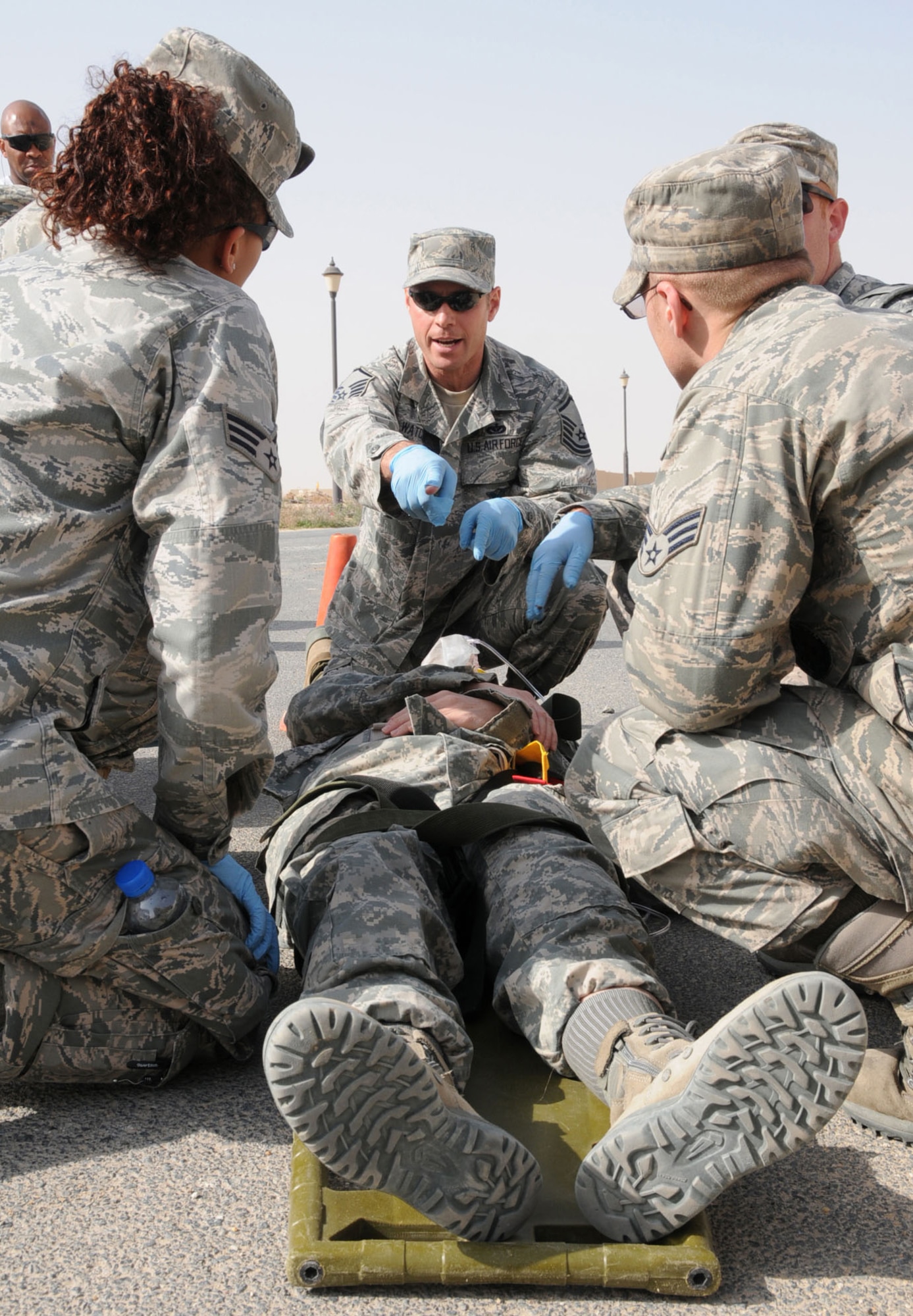 U.S. Air Force Master Sgt. Mark Watczak, 386th Expeditionary Civil Engineering Squadron Fire Department, directs his team during an EMT Rodeo hosted by the 386th Expeditionary Medical Group in an undisclosed location, Southwest Asia, Feb. 18, 2012.  Watczak, native to Houlton, Wis., deployed from the 148th Civil Engineering Squadron, Duluth, Minn., and his emergency medical technician team participated in the competition to test their skills and knowledge in responding to different emergency situations alongside military and civilian EMT personnel from the Air Force, Army, and Navy. (U.S. Air Force photo by Staff Sgt. James Lieth/Released)