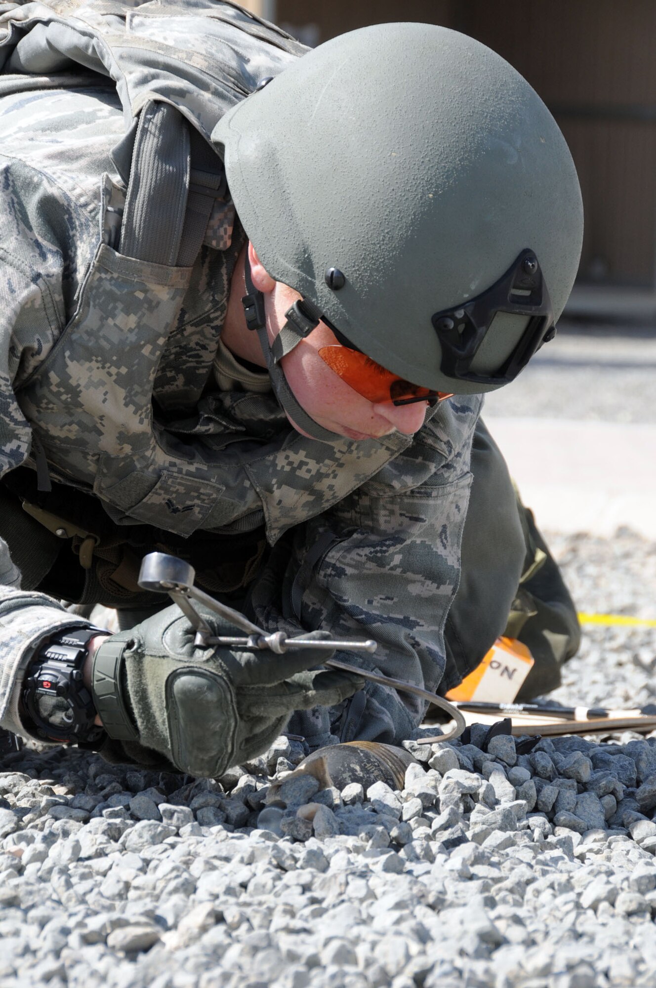 U.S. Air Force Airman 1st Class Katelyn Crosby, 386th Expeditionary Civil Engineering Squadron explosive ordnance technician, measures simulated unexploded ordnance (UXO) in an undisclosed location in Southwest Asia, Feb. 21, 2012. Crosby, deployed from the 31st CES, Aviano Air Base, Italy, measured the UXO during a "bunker dive" exercise used to evaluate the overall readiness of base personnel and facilities while under a simulated attack. (U.S. Air Force photo by Staff Sgt. James Lieth/Released)