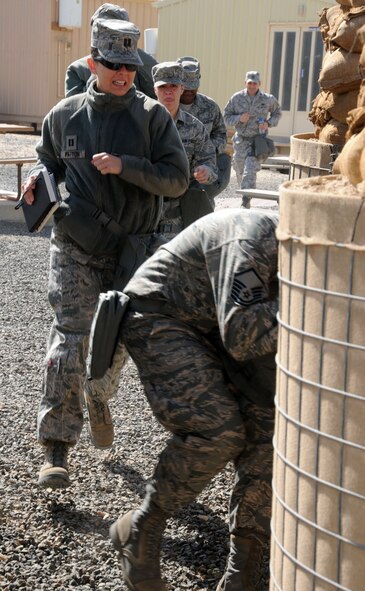 SOUTHWEST ASIA – Capt. Amanda Patton and members of the 386th Air Expeditionary Wing, run to a bunker, Feb. 21, 2012. The 386th AEW conducted a "bunker dive" exercise to evaluate the overall readiness of base personnel and facilities while under a simulated attack. Patton, 509th Force Support Squadron military personnel section chief, returned June 12, from her six-month deployment. (U.S. Air Force photo by Staff Sgt. James Lieth/Released)