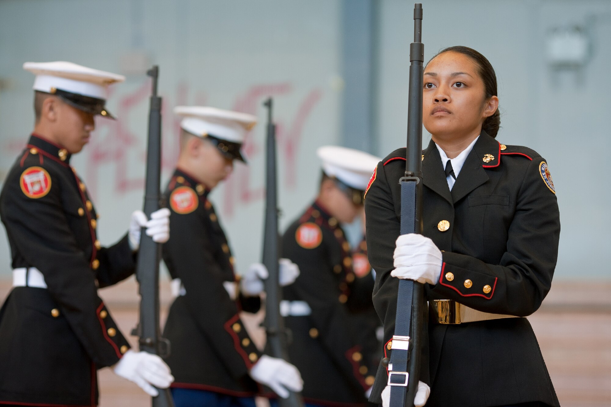 YOKOTA AIR BASE, Japan -- Cadet Maj. Emmanuelle Cordero, 12th grader from Kubasaki High School Junior Reserve Officers' Training Corps, Camp Foster, Okinawa, Japan, performs armed drill movements with her team during the regional drill meet at Yokota High School, Feb. 18, 2012. Seven, U.S. Department of Defense Dependents High Schools participated in the meet. The Nile C. Kinnick High School from the Commander Fleet Activities, Yokosuka received 1st place. (U.S. Air Force photo/Osakabe Yasuo)  