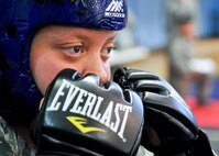 Senior Airman Brooke Walker, 51st Security Forces Squadron member, prepares to engage her opponent during the combatives portion of a Combat Readiness Course here, Feb. 21, 2012. The matches were three minutes long and ended by submission or time lapse. (U.S. Air Force photo/Senior Airman Adam Grant)