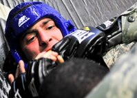 Airman 1st Class Brett McIsaac, 51st Security Forces Squadron member, attempts to prevent his opponent from mounting him during the combative portion of a Combat Readiness Course here, Feb. 21, 2012. Airmen are awarded points for good fighting habits and for emphasizing the importance of dominant body positions.  (U.S. Air Force photo/Senior Airman Adam Grant)