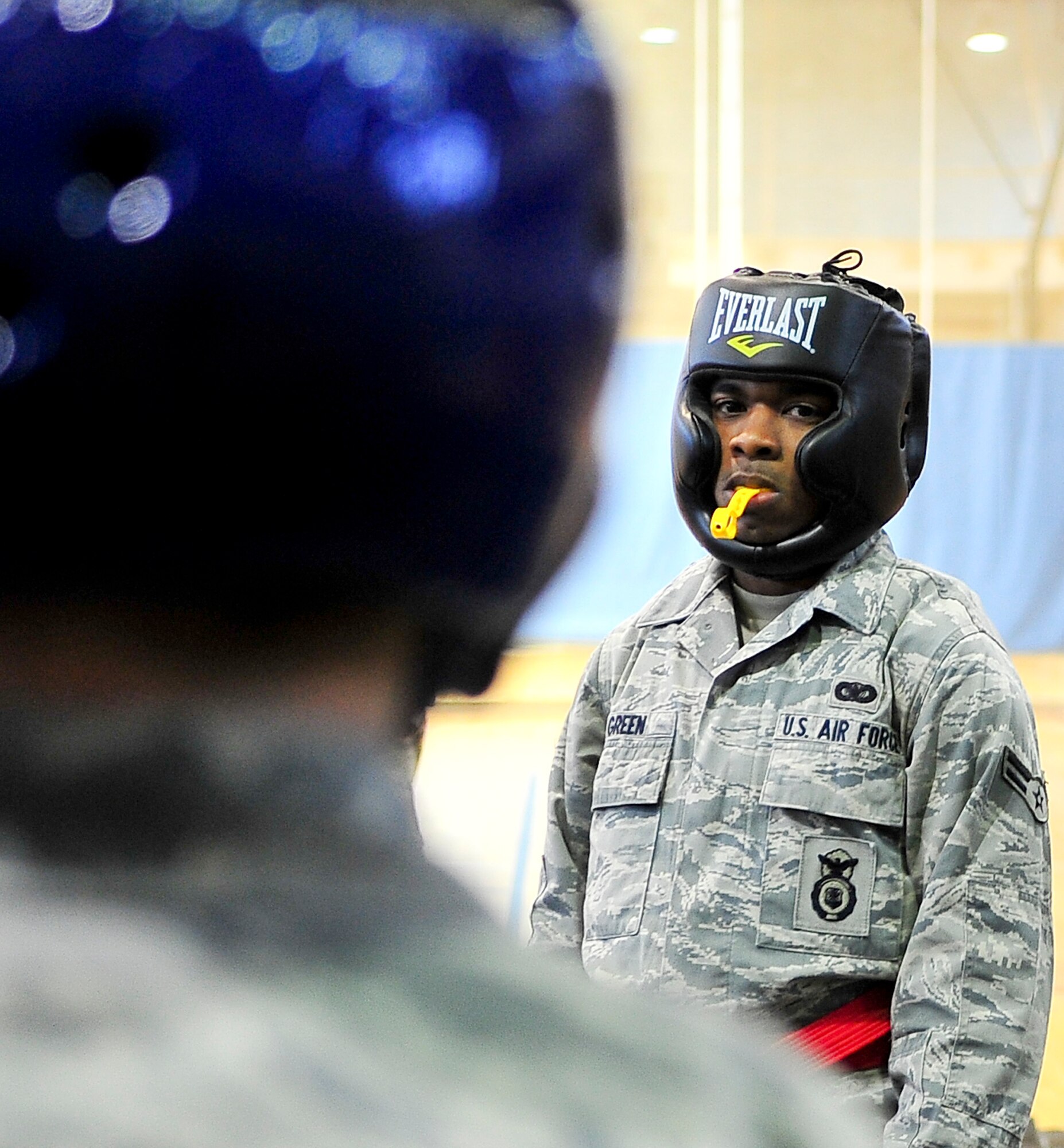 Airman 1st Class Tyquan, Green 51st Security Forces Squadron member, stares down his opponent during the combatives portion of a Combat Readiness Course here, Feb. 21, 2012. The combatives portion of the CRC tests Airmen’s abilities to defend themselves when placed in threatening situations.  (U.S. Air Force photo/Senior Airman Adam Grant)