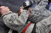 Staff Sgt. Curtis Cain, 51st Security Forces Squadron member, holds his opponent in a submission move during the combatives portion of a Combat Readiness Course here, Feb. 21, 2012. Airmen are awarded points for good fighting habits and for emphasizing the importance of dominant body positions. (U.S. Air Force photo/Staff Sgt Craig Cisek)