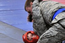 Senior Airman Joshua Davies, 51st Security Forces Squadron member, is pinned down by his opponent during the combative portion of a Combat Readiness Course here, Feb. 21, 2012. The combative portion of the CRC tests the Airmen’s abilities to defend themselves when placed in threatening situations. (U.S. Air Force photo/Staff Sgt Craig Cisek)