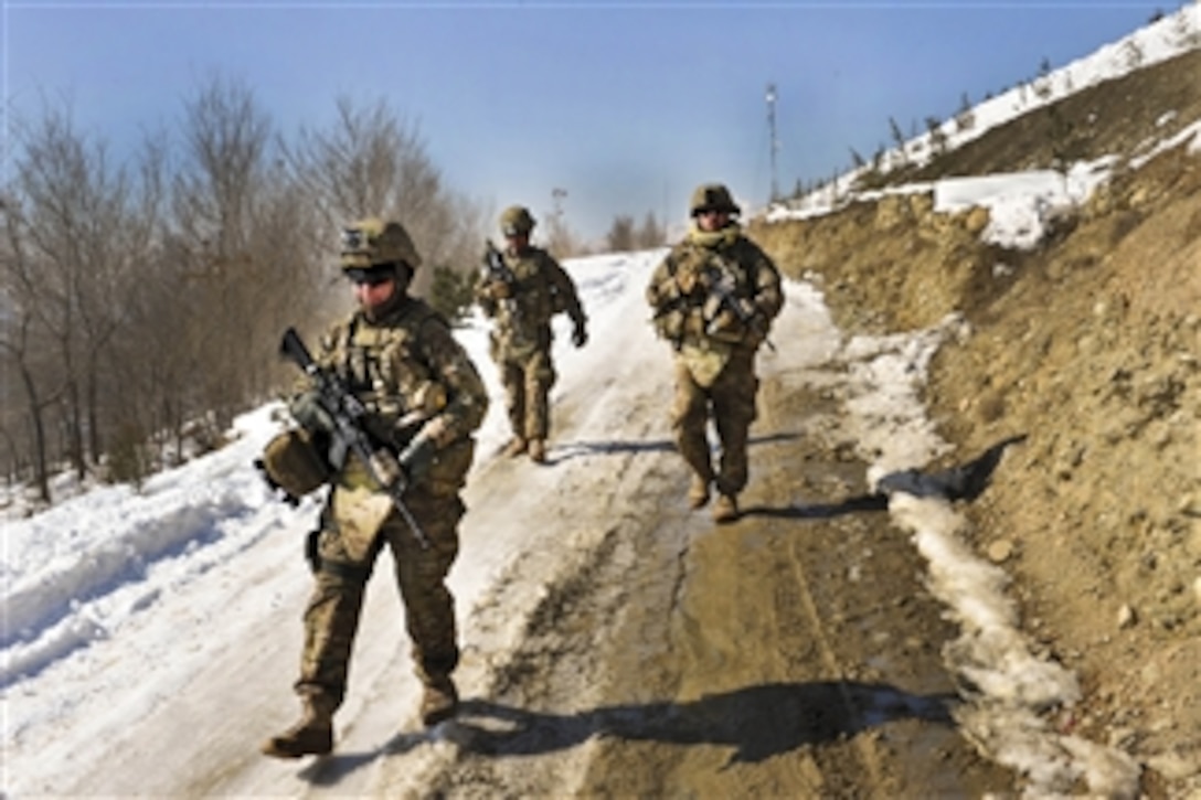 U.S. Army Sgt. Crystal Cornejo (left), Staff Sgt. Farrell Thomey (right) and Sgt. Patrick Deleonguerrero (2nd from left) maneuver down a snow and ice covered hill during a presence patrol in Kabul, Afghanistan, on Feb. 9, 2012.  Cornejo, Thomey and Deleonguerrero are assigned to the 1186th Military Police Company.  
