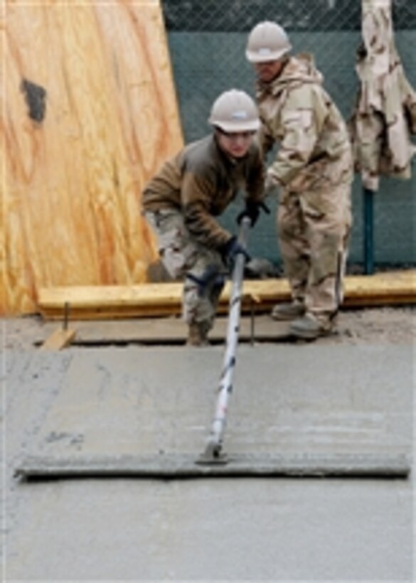 Petty Officer Selina Rodriguez, assigned to Naval Mobile Construction Battalion 7, uses a bull float to finish concrete at Kandahar Airfield on Feb. 17, 2012.  Naval Mobile Construction Battalion 7 and its detachments are one of two Seabee battalions supporting the International Security Assistance Force as part of Task Force Stethem, operating in the U.S. Central Command area of responsibility.  