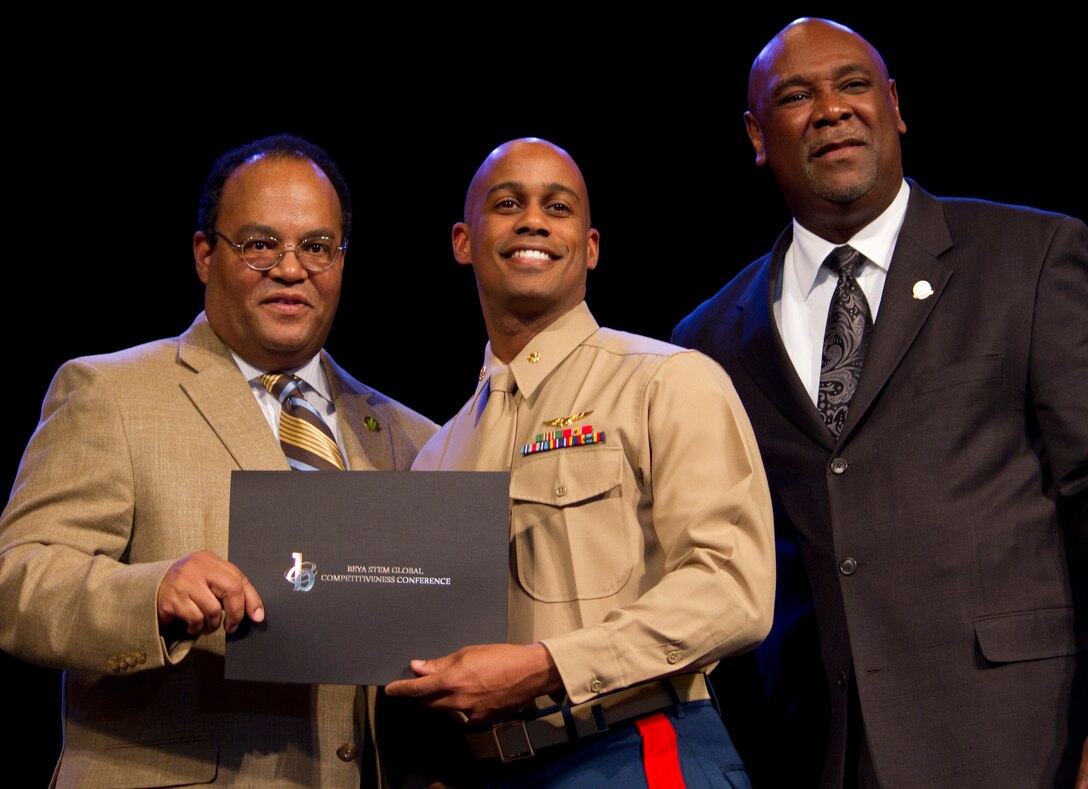 Tyrone Taborn, Career Communications Group Publisher, and Kendall T. Harris, Prairie View A&M University Engineering Dean, present Maj. Ralph Featherstone, operations analyst, Headquarters Marine Corps, Manpower Reserve Affairs, with the Modern Day Technology Leadership award, at the Modern Day Technology Leadership Luncheon, part of the 26th Annual National Black Engineer of the Year Awards (BEYA) Science Technology Engineer Math (STEM) Global Competitiveness Conference, Feb. 17, Philadelphia. These awardees are women and men who are shaping the future of engineering, science, and technology. The luncheon led into the 7th Annual Stars and Stripes Dinner, which was hosted by the Marine Corps. Gen. James F. Amos, Commandant of the Marine Corps, was the keynote speaker, and stressed the importance of reaching out to the best and brightest technology minds in the country.