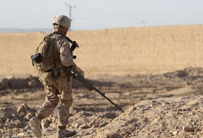 Lance Cpl. Edgar Lima, a sweeper with 2nd Squad, 1st Platoon, Lima Company, scans the area for improvised explosive devices while patrolling in Wishtan, Feb. 22. Lima, a graduate of Mission Bay High School in San Diego, is currently deployed with 3rd Battalion, 7th Marine Regiment. On one occasion, Lima helped identify a 40-pound improvised explosive device with 39 sticks of dynamite.