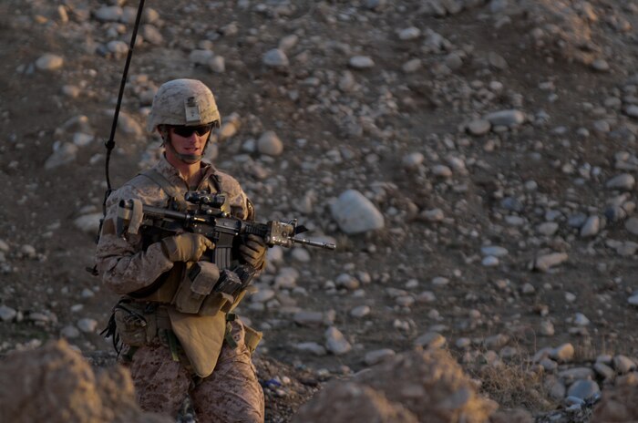 Cpl. David Wood, a squad leader with 1st Platoon, Lima Company, 3rd Battalion, 7th Marine Regiment, patrols through the town of Wishtan, Feb. 22. At times, Afghan children surrounded Wood and his Marines, asking questions and trying to trade items. Wood said he sees a difference from when he was deployed to Sangin last year.