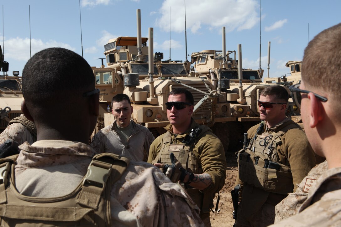 Cpl. Nickolas Gervasoni, a military policeman and a security team leader, Engineer Support Company, 9th Engineer Support Battalion, 1st Marine Logistics Group (Forward) debriefs his security team following a mission in Helmand province Feb. 22. The security, which is made up of primarily junior Marines and a few noncommissioned officers, provides safety for convoys traveling from point A to point B and for engineering operations while at fixed locations throughout Helmand province. In addition, the team is responsible for driving the security trucks, communications between vehicles and manning the crew-served weapons.