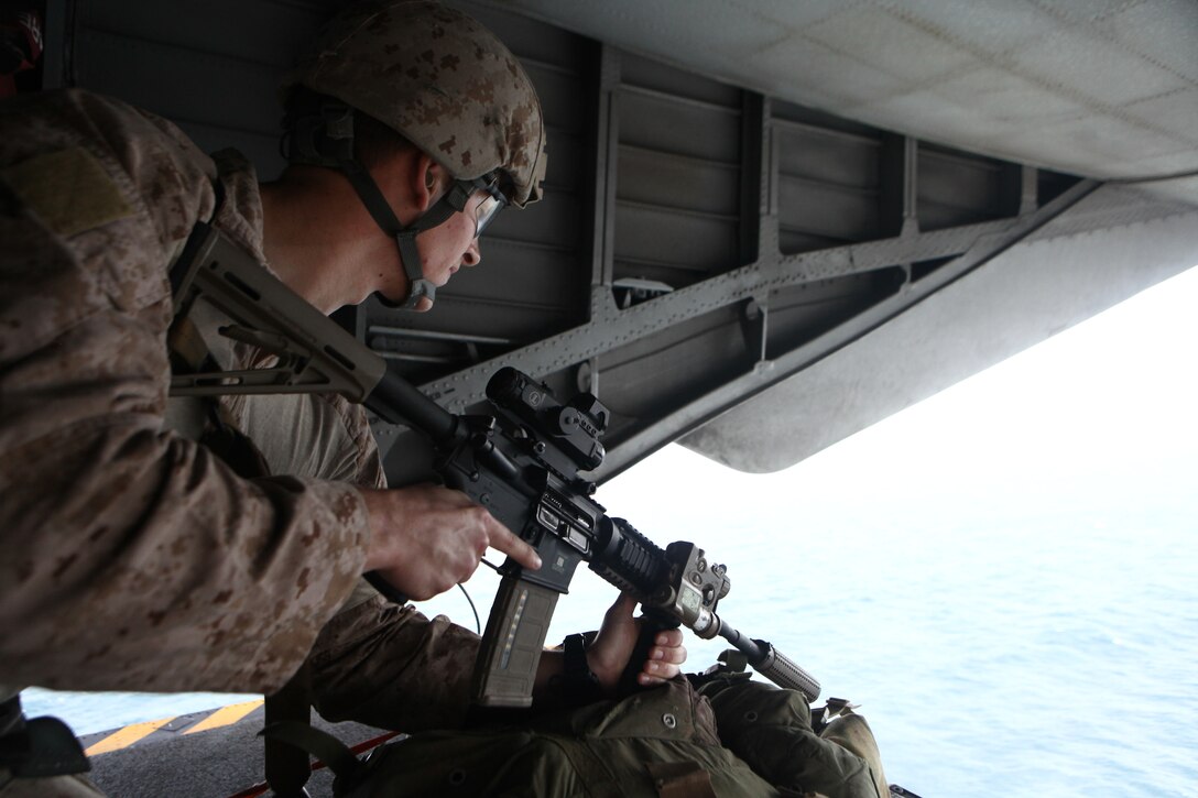 Petty Officer 3rd Class John Allen fires from an airborne CH-53E Super Stallion during target practice here Feb. 22. The 23-year-old Nampa, Idaho, native serves with the 11th Marine Expeditionary Unit's maritime raid force. The unit is deployed as part of the Makin Island Amphibious Ready Group, a U.S. Central Command theater reserve force. The group is providing support for maritime security operations and theater security cooperation efforts in the U.S. Navy's 5th Fleet area of responsibility.