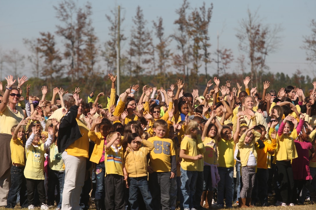 Children, civilians and service members stand together at the Carolina Forest Elementary School soccer field in an attempt to break the Guinness World Record of the largest human yellow ribbon, Nov. 3. In support of November’s Month of the Military Family, children from elementary schools to high schools throughout Jacksonville, N.C., as well as civilian and service members, came together to recognize the sacrifices of those involved in serving the country.