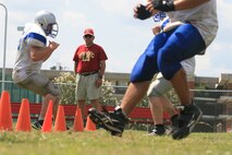 Coach Bill Stinkowski watches the New River Knights conduct speed drills on the practice field aboard Marine Corps Air Station New River Aug. 23. The Knights are training for the seasons first game next month.