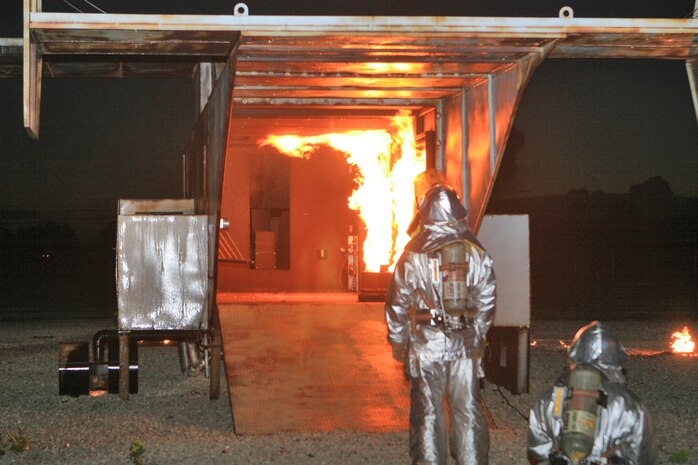 Marines from Aircraft Rescue and Fire Fighting wait for the simulated MV-22B Osprey to catch fire before they rush in to put it out, Aug. 19. ARFF Marines aboard Marine Corps Air Station New River  conduct live-fire training as often as they can.