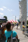 Michelle L. Addis records her two sons, Brian and Chandler as they climb up a wall. Marine Corps Air Station New River hosted a Kid's Day in the station theater parking lot to prepare children to go back to school, Aug. 16.