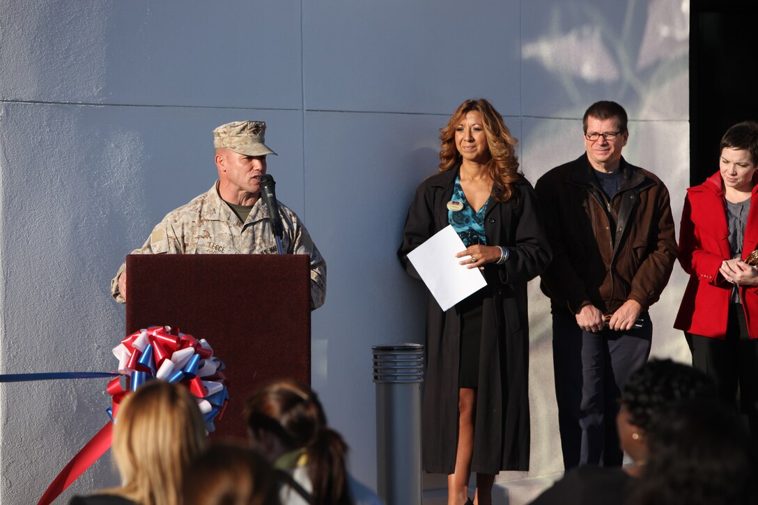 Col. Daniel J. Lecce (left), commanding officer of Marine Corps Base Camp Lejeune, speaks to service members , family and friends during the ribbon-cutting ceremony at the Marine COrps Exchange grand opening, Nov. 2