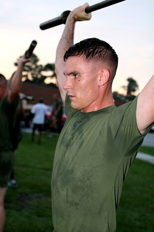 Cpl. Christopher White performs overhead presses during a High Intensity Tactical Training class, Aug. 10.