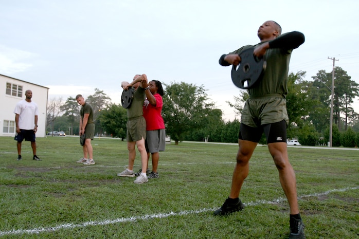 Raymond Anderson, center, the Marine Corps Air Station New River High Intensity Tactical Training coordinator, coaches Marines to proper HITT form during a 12-week trial before the program's scheduled release in December.