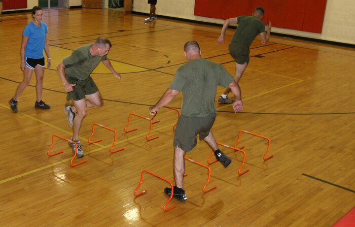 Samantha Stewart, left, a personal trainer with Semper Fit, observes Marines doing speed drills during a High Intensity Tactical Training class, Aug. 10.