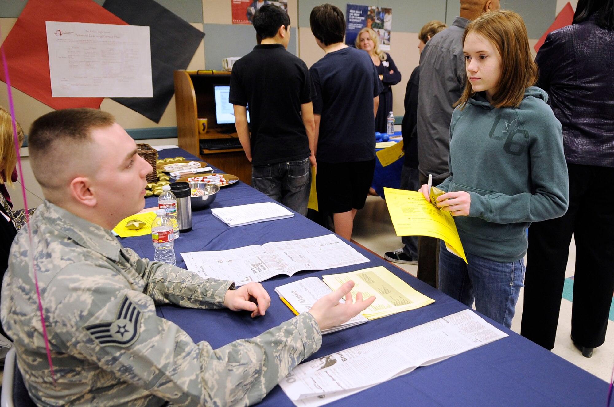 U.S. Air Force Staff Sgt. Jacob Worden, 354th Comptroller Squadron NCO in charge of finance customer support, speaks to Chelsea LeBlanc, daughter of Tech. Sgt. Christopher LeBlanc, 354th Civil Engineer Squadron, during career day at Ben Eielson High School, Feb. 16, 2012, Eielson Air Force Base, Alaska. Worden explained Air Force finance career opportunities to interested students in 8th through 11th grade. (U.S. Air Force photo/Staff Sgt. Jim Araos)
