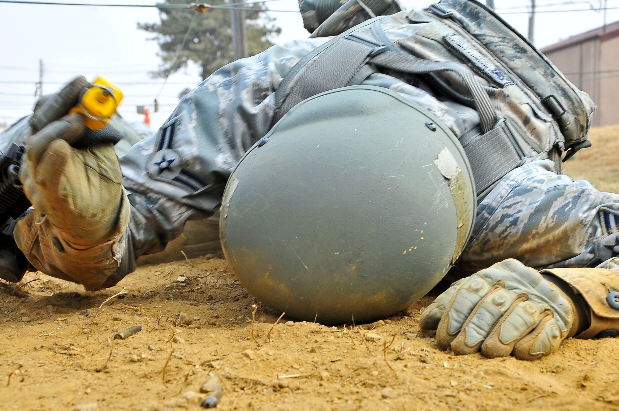An Airman low crawls 30 yards during the confidence course portion of the Combat Readiness Course here, Feb. 23, 2012. The confidence course tests the participants’ ability to survive as a team while communicating   when place in stressful situations. (U.S. Air Force photo/Senior Airman Adam Grant)
