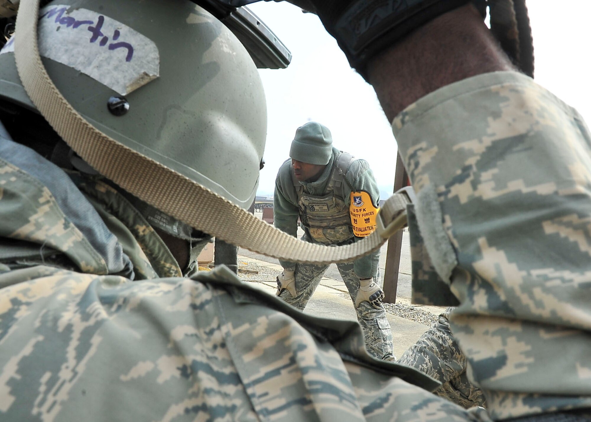 Staff Sgt. Antonio Chatman, 51st Security Forces Squadron instructor, observes as Airmen answer questions during the confidence course portion of the Combat Readiness Course here, Feb. 23, 2012. The CRC happens once a month and is offered to all new security forces members. (U.S. Air Force photo/Senior Airman Adam Grant)