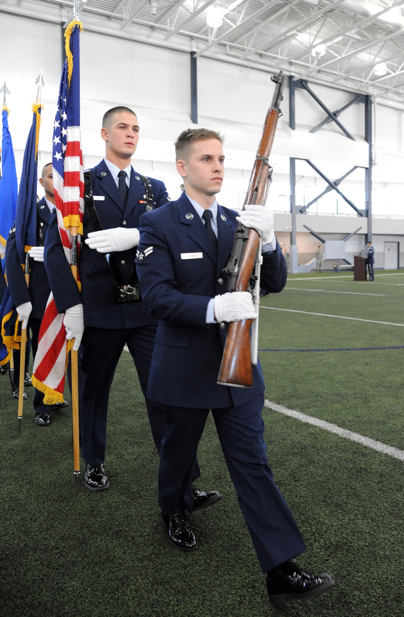 U.S. Air Force Airmen 1st Class Zachary Perras and Shalen Williams, Eielson Air Force Base Honor Guard members, march during a demonstration of an honor guard ceremony Feb. 17, 2012, at Baker Field House, Eielson Air Force Base, Alaska. The demonstration, along with a graduation ceremony, rounded out a week’s worth of honor guard training for 28 new members. Perras is a public affairs technician assigned to the 354th Fighter Wing and Williams is a security forces journeyman assigned to the 354th Security Force Squadron. (U.S. Air Force photo/ Senior Airman Willard E. Grande II)