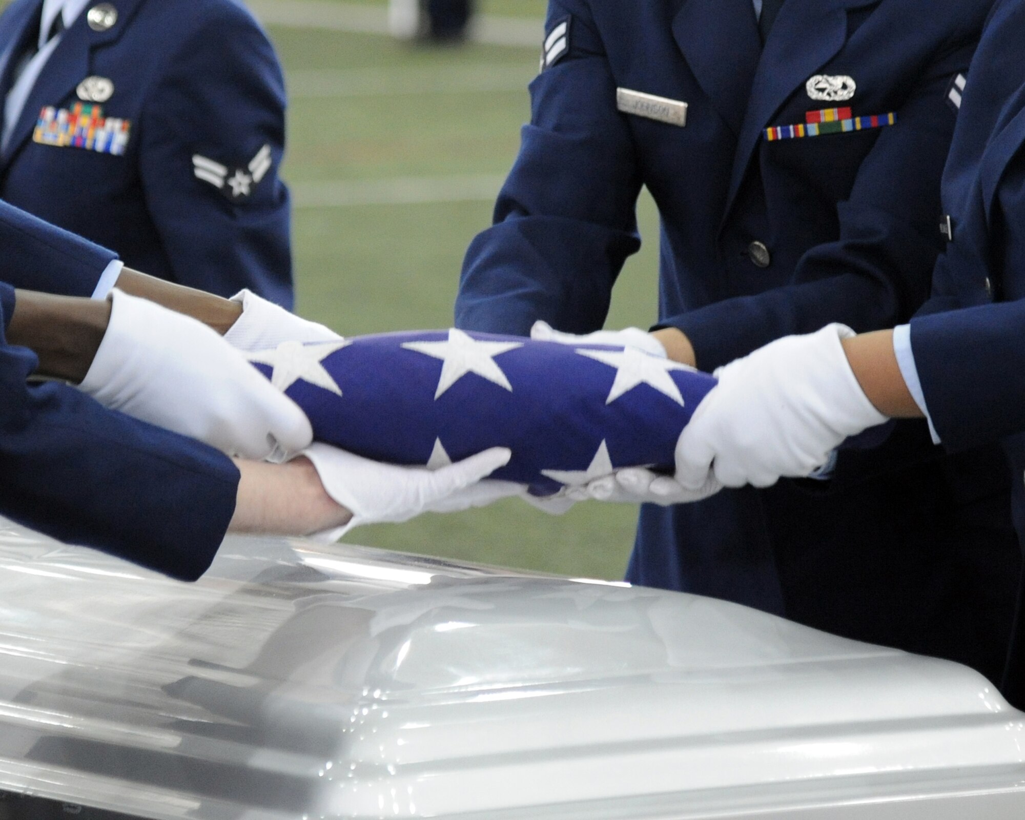 Members of the Eielson Air Force Base Honor Guard fold the American Flag during a demonstration of an honor guard ceremony Feb. 17, 2012, at Baker Field House, Eielson Air Force Base, Alaska. The demonstration was representative of a military funeral with full honors and was the final event of a week’s worth of honor guard training. (U.S. Air Force photo/ Senior Airman Willard E. Grande II)
