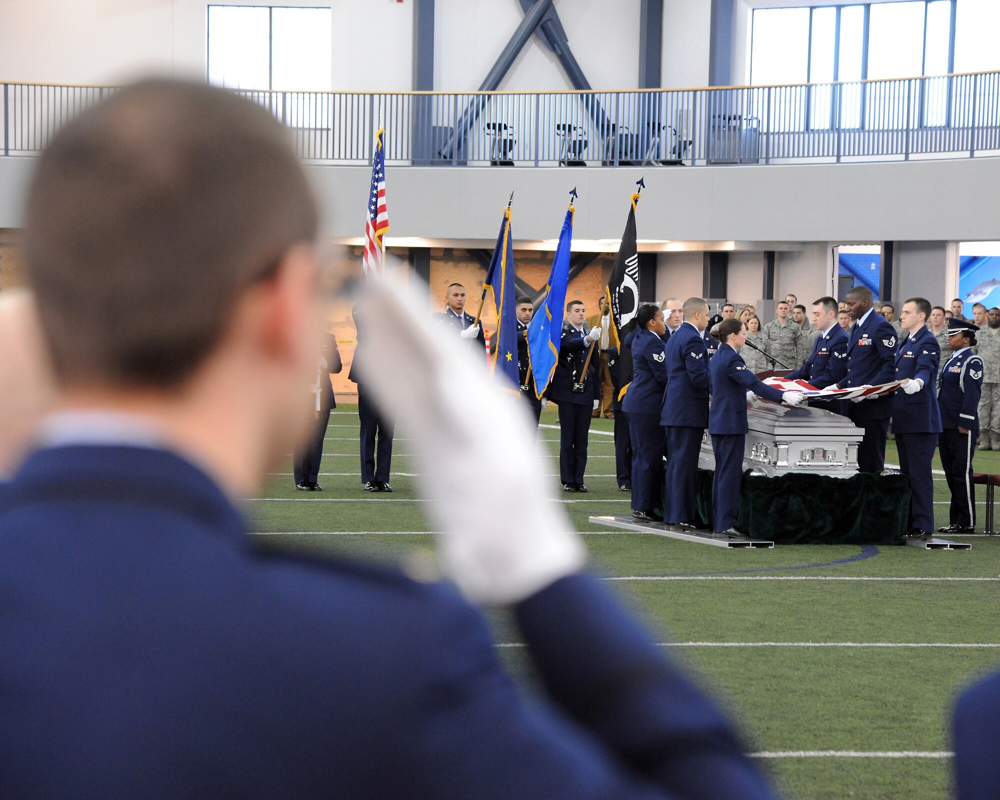 A member of the Eielson Air Force Base Honor Guard salutes during a demonstration of an honor guard ceremony Feb. 17, 2012, at Baker Field House, Eielson Air Force Base, Alaska. The demonstration was conducted with a graduation ceremony as the final event of a week’s worth of honor guard training for 28 new members. (U.S. Air Force photo/Senior Airman Willard E. Grande II)