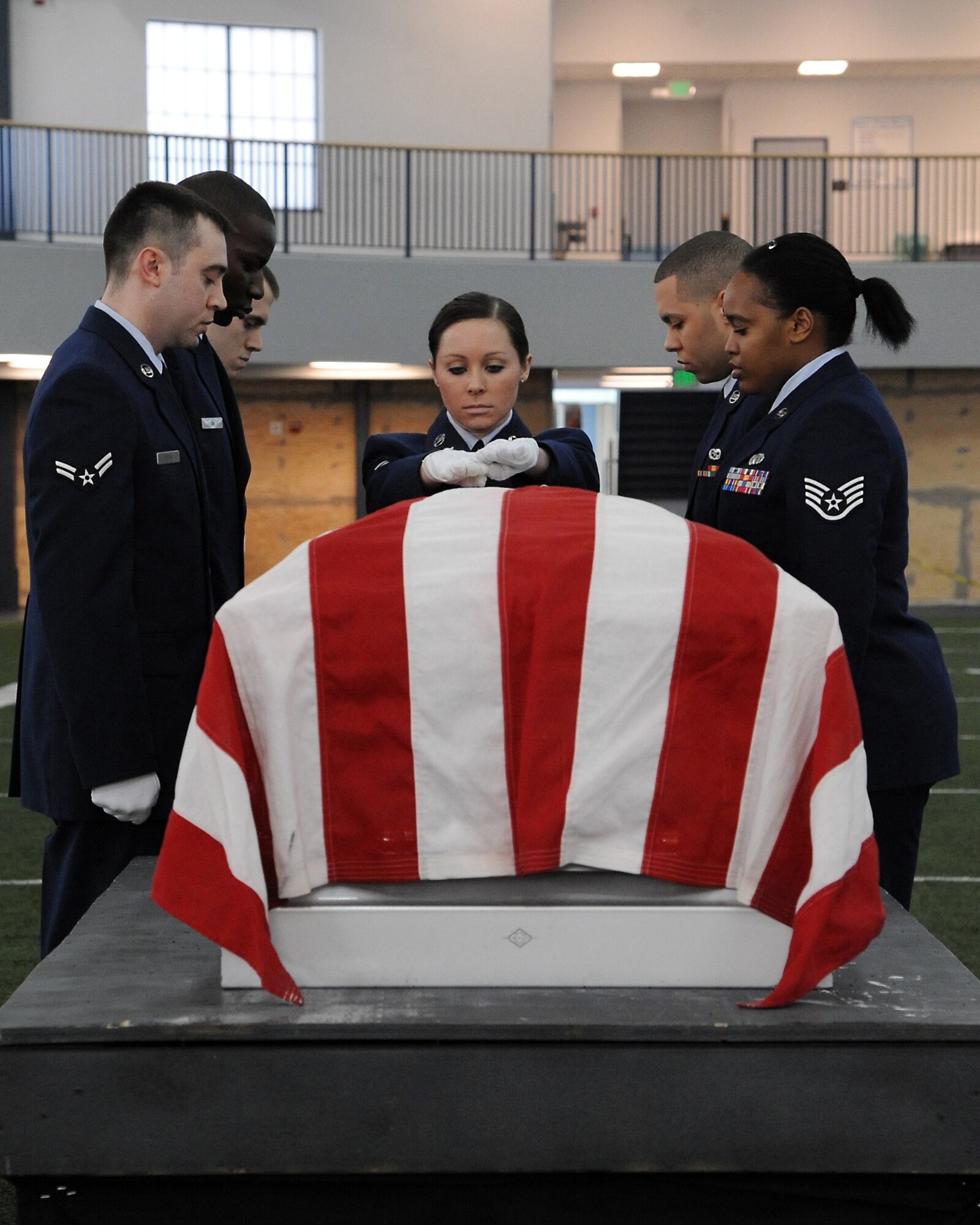 Members of the Eielson Air Force Base Honor Guard prepare to lift a casket during a demonstration of an honor guard ceremony Feb. 17, 2012, at Baker Field House, Eielson Air Force Base, Alaska. The demonstration was representative of a military funeral with full honors. (U.S. Air Force photo/ Senior Airman Willard E. Grande II)