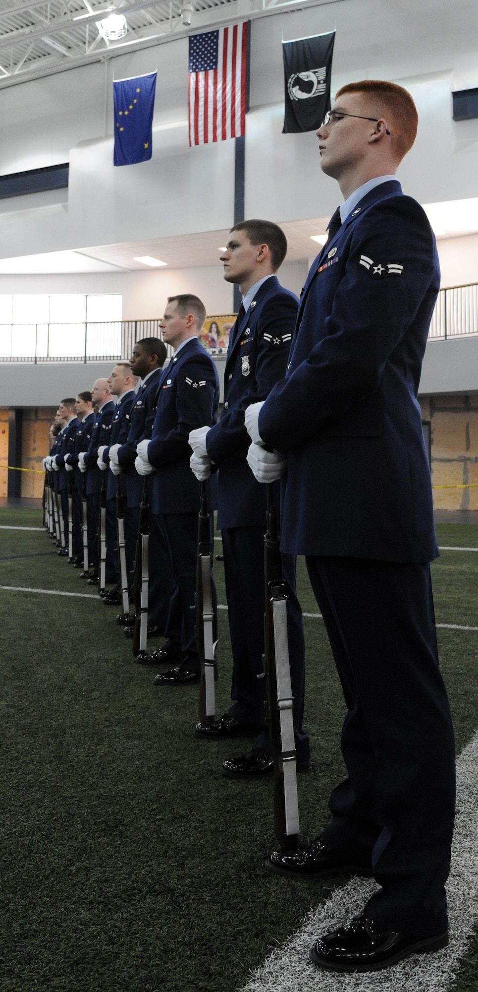 Members of the Eielson Air Force Base Honor Guard stand in formation during a demonstration of an honor guard ceremony Feb. 17, 2012, at Baker Field House, Eielson Air Force Base, Alaska. The new honor guardsmen successfully completed a week’s worth of honor guard training. (U.S. Air Force photo/ Senior Airman Willard E. Grande II)
