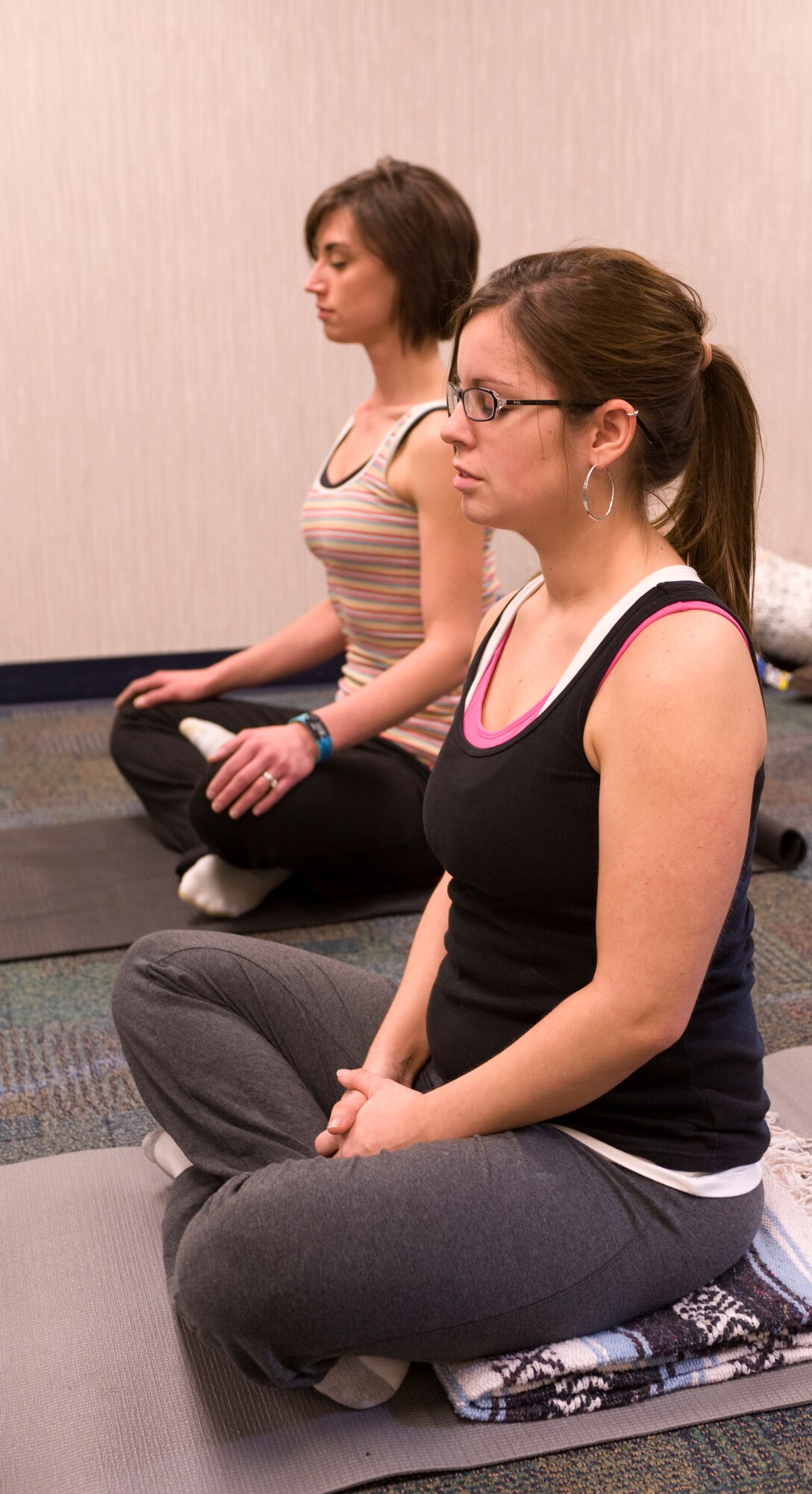 Lisa Merriss, right, wife of Airman 1st Class Eric Merriss, 28th Operations Support Squadron intel anaylsis, and Michelle Haleck, registered dietician, practice breathing exercises during the Fit Pregnancy yoga class at the Health and Wellness Center on Ellsworth Air Force Base, S.D., Feb. 16, 2012.  The Fit Pregnancy program offers yoga and includes information on proper nutrition for pregnant women.  (U.S. Air Force photo by Airman 1st Class Anania Tekurio/Released)