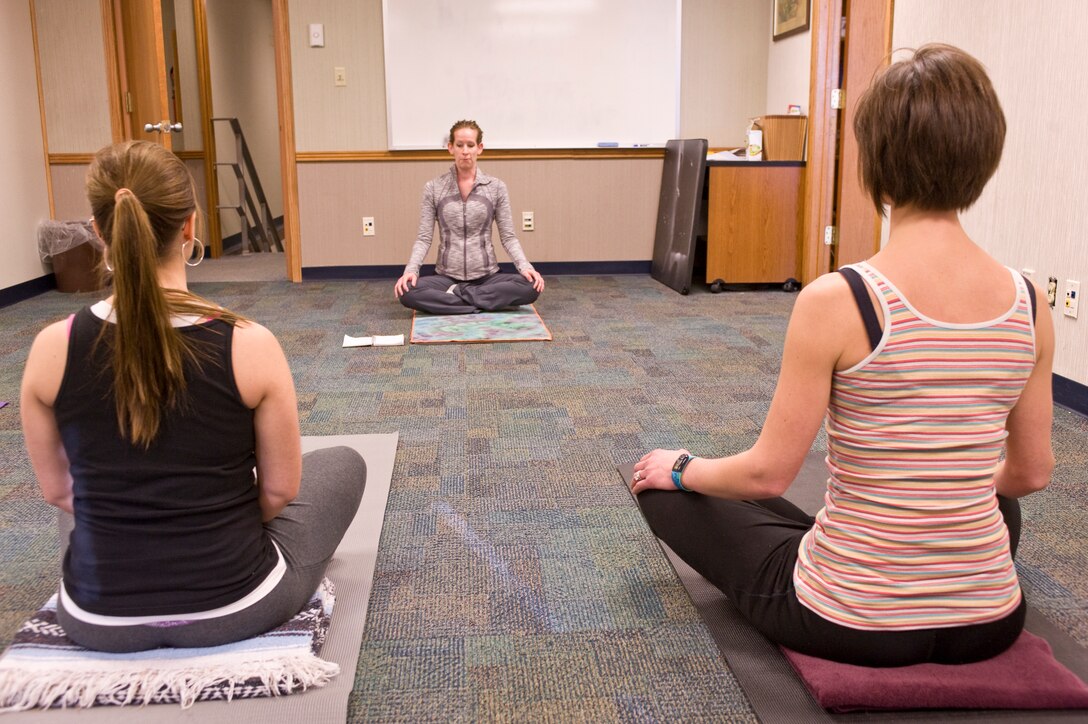 McKay Moore, yoga instructor, demonstrates yoga breathing techniques to Lisa Merriss, wife of Airman 1st Class Eric Merriss, 28th Operations Support Squadron intel analysis, and Michelle Haleck, registered dietician at the Health and Wellness Center during the Fit Pregnancy yoga class on Ellsworth Air Force Base, S.D., Feb. 16, 2012.  The classes for pregnant women available to active duty and dependents stationed here at Ellsworth.  (U.S. Air Force photo by Airman 1st Class Anania Tekurio/Released)  