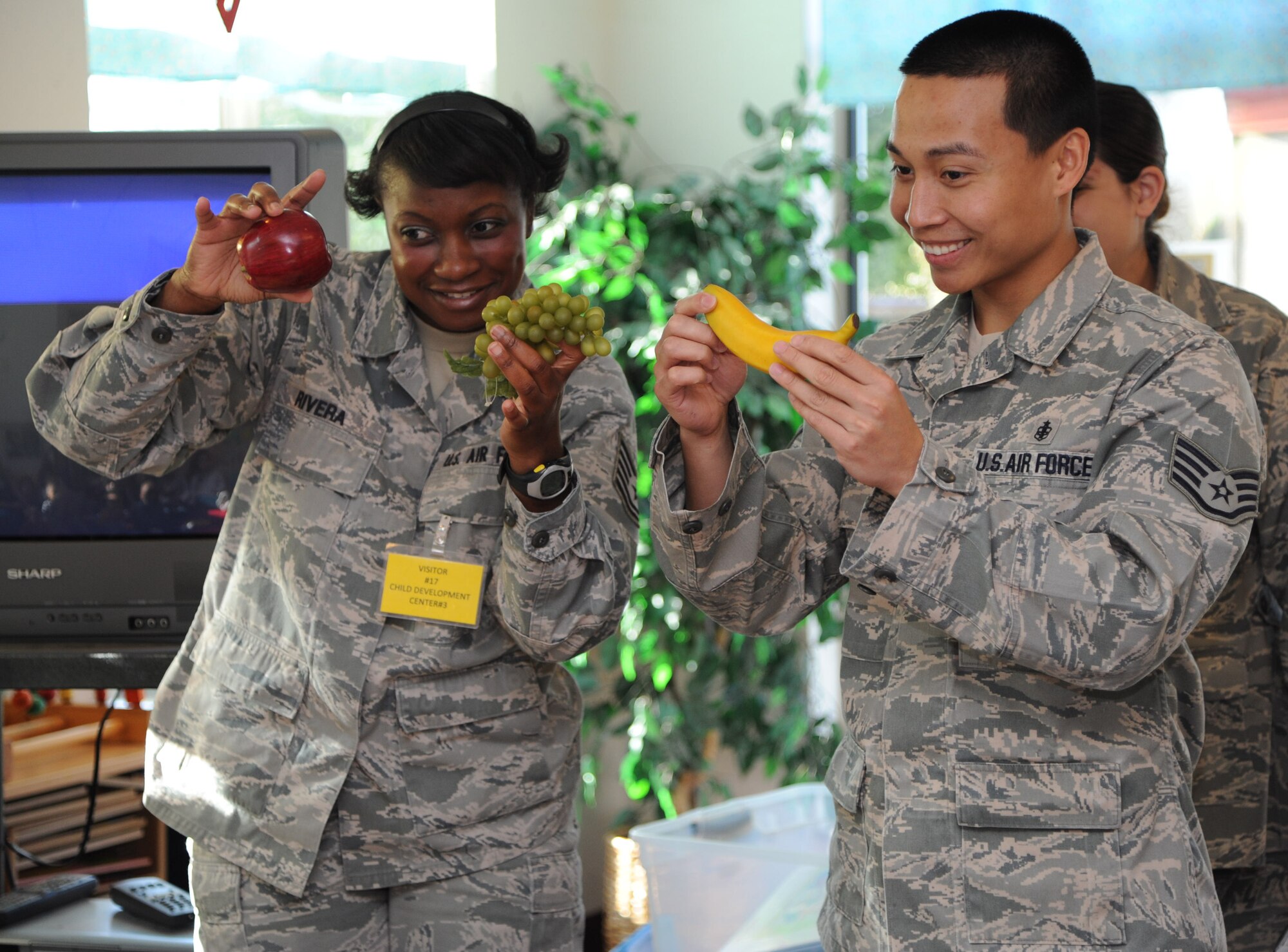 Tech. Sgt. Demarris Rivera and Staff Sgt. Joseph Imperial, 60th Dental Squadron, show pre-school aged children the right foods to eat to keep kids healthy at the Child Development Center Feb. 16. (U.S. Air Force photo/Airman 1st Class Nicole Leidholm)