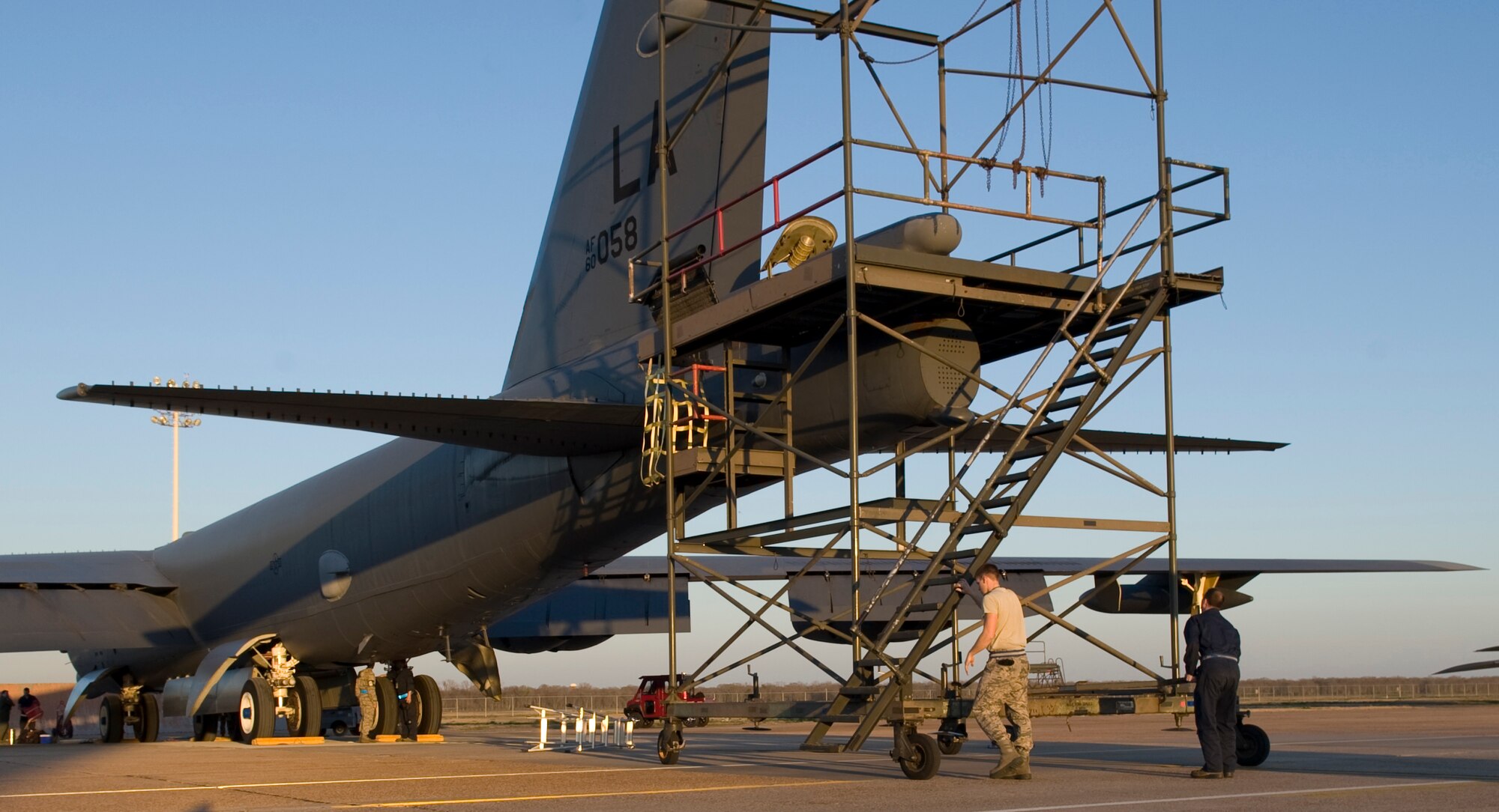 Airmen from the 20th Aircraft Maintenance Unit place a drogue chute stand behind a B-52H Stratofortress on Barksdale Air Force Base, La., Feb. 22. The stand provides Airmen stability and convenience when packing the chute equipment into the aircraft.  (U.S. Air Force photo/Airman 1st Class Benjamin Gonsier)(RELEASED)